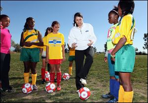Mia Hamm, center, along with Kristine Lilly, and Tisha Venturini-Hoch (not pictured) will lead the TeamFirst Soccer Academy, which begins today at the Glass Bowl at the University of Toledo. It's a soccer skills camp for girls ages 8-19, but the environment also allows Hamm to pass along the values that playing soccer has taught them.