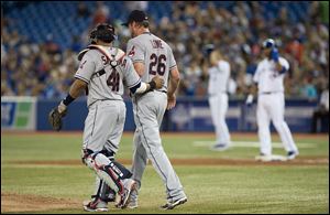 Cleveland Indians pitcher Derek Lowe, right, talks with catcher Carlos Santana during third inning Sunday in Toronto. The Indians lost 3-0 to the Blue Jays.