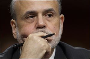 Federal Reserve Board Chairman Ben Bernanke pauses before giving a  semiannual report to the Senate Banking Committee Tuesday on Capitol Hill.