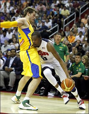 Team USA guard Kevin Durant, right, tries to get past Brazil's Tiago Splitter during the first half of an Olympic men's exhibition basketball game, Monday.