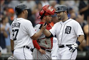 Detroit Tigers' Alex Avila, right, celebrates his two-run home run with Jhonny Peralta  in the second inning Thursday.