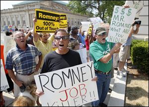 Gus Nickolas of Canton, center, joins the crowd of 35 protesters outside the Toledo Club, where a fund-raiser was held for Mitt Romney.