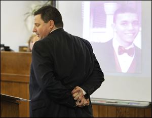 Assistant Lucas County Prosecutor Rob Miller demonstrates how Johnny Clark's hands were bound behind his back, during his opening statement at Samuel Williams'  trial.