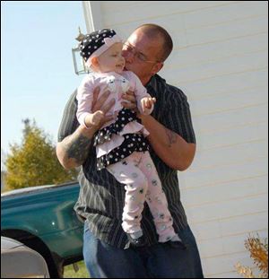 William May of Toledo holds his daughter, McKenna, in a Facebook photo. Mr. May said he initially hesitated to sign the paperwork for McKenna to go to Disney World because he wanted the rest of McKenna's family to be able to celebrate her wish with her.