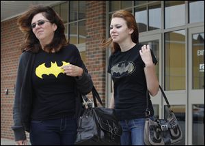 ‘It's sad that it's not even safe to go to the movies,' said Amy Jankowski of Oregon, left, who saw ‘The Dark Knight Rises' on Friday with her daughter, Sabrina, 15, at the Rave cinema in Levis Commons. ‘I'm thinking they're taking away the enjoyment.'