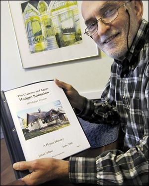 Julian Sellers shows the paper that chronicles the history of his bungalow, from its structure and its environs to the family who first lived there. Mr. Sellers is a member of the Twin Cities Bungalow Club.