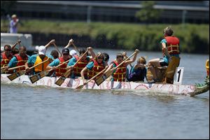 The Toledo Refining Company team races toward the finish line during the 11th Annual Drago Boat Festival at International Park in Toledo.