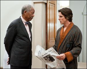 Morgan Freeman as Lucius Fox, left, and Christian Bale
as Bruce Wayne in a scene from ‘The Dark Knight Rises.’