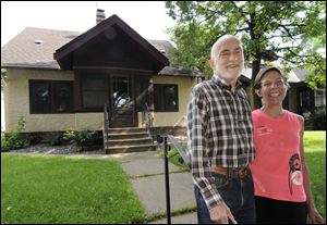 Julian Sellers and his wife, Barbara, pose in front of their bungalow in St. Paul. The Sellerses learned through painstaking research that the construction of their home was started in 1926 and was finished in early 1927 by the builder, who was a Swedish immigrant.