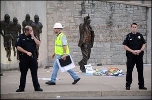 Police and construction workers have surrounded the Joe Paterno statue in State College, Pa.
