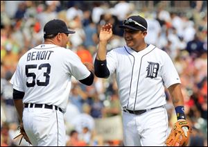 Detroit Tigers third baseman Miguel Cabrera high-fives relief pitcher Joaquin Benoit (53) after their 6-4 win over the Chicago White Sox in a baseball game in Detroit today.