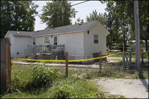 Crime-scene tape surrounds the residence in Perrysburg Township
where Leandra Dominique Frankum Frankum was killed.