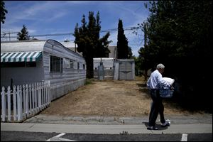 Ralph Meyers, 86, walks to a laundry room at the Santa Monica Village Trailer Park in Santa Monica, Calif. The city's Planning Commission recently recommended the 3.8-acre park's zoning be changed to allow a developer to bulldoze its modest, rent-controlled homes and replace them with nearly 200 much-higher-priced apartments and condominiums, as well as more than 100,000 square feet of office and retail space.