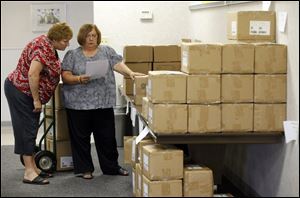 Brenda Mocek, left, and Kristina Schwarzkopf of the Toledo Federation of Teachers sort through materials provided by First Book.