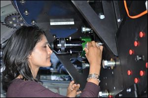 Rupali Chandar, an associate professor of astronomy at the University of Toledo, looks through the Discovery Channel Telescope. Ms. Chandar has previously worked with Hubble Space Telescope images.