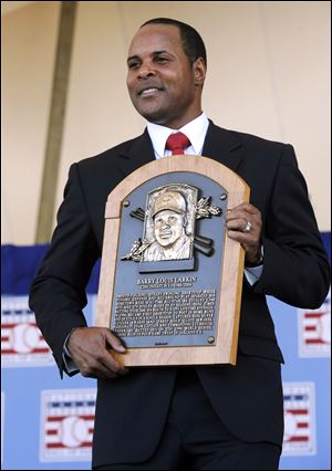Former Cincinnati Reds star Barry Larkin holds his plaque after his induction into the National Baseball Hall of Fame and Museum during Sunday's ceremony in Cooperstown, N.Y.