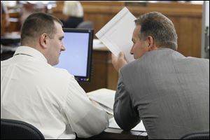 Samuel Willliams, left, speaks with his defense attorney John Thebes, during his death penalty case where he is charged in the ashyxiation deaths of Johnny Clarke and Lisa Straub.
