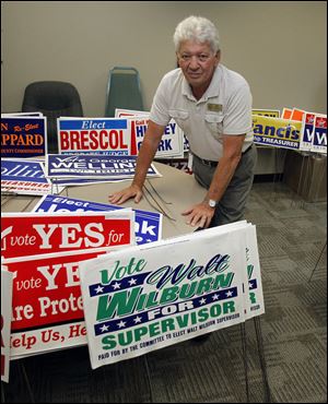 Walt Wilburn, Bedford Township supervisor, is surrounded by signs that residents have turned in after finding them on their properties. Hundreds of political signs have been stolen; the thefts do not seem to be aimed at any particular candidate, party, or issue, officials said.
