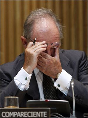 Rodrigo Rato, former chairman of the Spanish bank Bankia and Spain's former deputy prime minister, pauses during a parliamentary hearing in Madrid. High borrowing costs are crippling Spain's economy.
