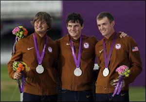 Brady Ellison, left, Jake Kaminski, and Jacob Wukie show off their silver medals in London. The U.S. teammates said they plan to store them in their sock drawers. The individual men’s archery competition begins Tuesday.