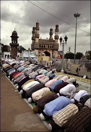 Indian Muslims offer first Friday prayers during Ramadan at Mecca Masjid in Hyderabad, India. Observers fast from dawn to dusk.