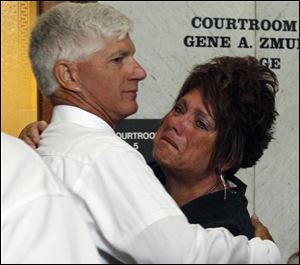 Jeff Straub, father of the murdered Lisa Straub, 20, embraces his sister-in-law Karen Verbosky after guilty verdicts were announced against Samuel Williams, 24, in Lucas County Common Pleas Court.