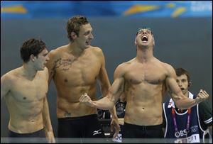 France's Clement Lefert, left, France's Amaury Leveaux, center, France's Fabien Gilot, back right, celebrate as they win gold in the men's 4x100-meter freestyle relay final at the Aquatics Centre in the Olympic Park during the 2012 Summer Olympics in London, Sunday.