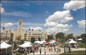 Visitors stroll among the exhibit tents. Art on the Mall drew 10,000 to 12,000 people Sunday to the University of Toledo, where most exhibitors were from Ohio and Michigan, but some were from Tennessee and Pennsylvania.