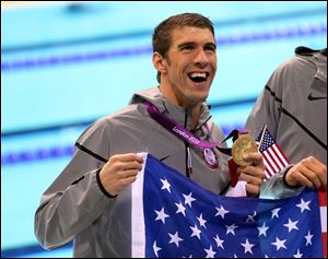 USA's Michael Phelps celebrates with his Gold Medal after winning the Men's 4 x 200m Freestyle Relay Final, the gold medal secured Phelps a record 19th Olympic medal, at the Aquatics Centre in the Olympic Park during the fourth day of the London 2012 Olympics.