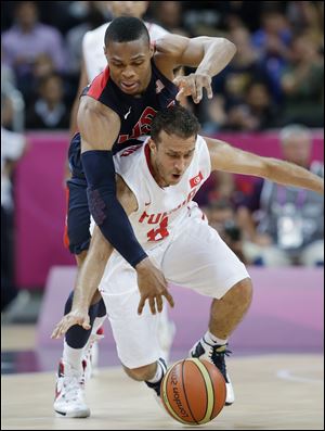 USA's Russell Westbrook, left, tries to steal the ball from Tunisia's Marouan Kechrid (8)during the first half of a preliminary men's basketball game at the 2012 Summer Olympics, Tuesday.