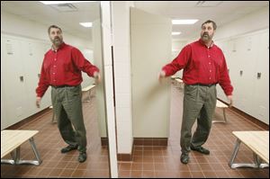 This 2010 photo shows Jon Eckel, director of public service, pointing out the amenities in the men's locker room in the $3.55 million public service building along Roachton Road.