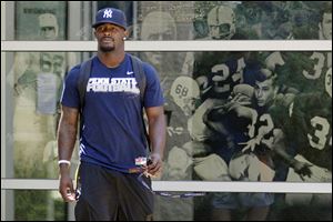 Penn State University football  running back Silas Redd leaves the Lasch Football building after a team meetings explaining the ramifications of the NCAA sanctions against the Penn State University football program in State College, Pa.,  Monday.