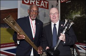 U.S. former athlete Harrison Dillard, left, the oldest living 100 metre gold medalist, poses with British Government Minister Alistair Burt, in London.