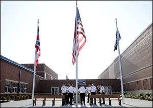 The flags are raised during a tour today of the new Lake High School.