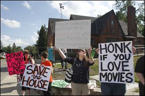 Demonstrators outside Bowling Green State University's Popular Culture House show their support for the venerable structure, which the university plans to demolish. The house was bought as a kit in 1932.