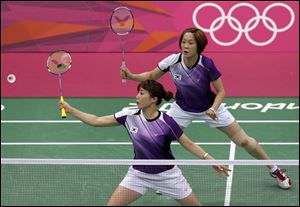 South Korea's Kim Min-jung, left, and Ha Jung-eun play against South Africa's Michelle Edwards and Annari Viljoen in a women's doubles badminton match. The South Korean players were disqualified for deliberately trying to lose.