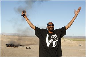 Snoop Dog blows up an armored truck to commemorate the 10 millionth visitor to Zynga's  Mafia Wars: Las Vegas.