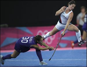 The United States' Michelle Vittese leaps as she battles for control of the ball against Argentina's Josefina Sruoga during a preliminary match. The U.S. won 1-0 in what many see as a significant victory.