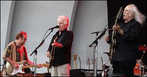 From left, Stephen Stills, Graham Nash, and David Crosby rock on at the Toledo Zoo Amphitheater.