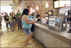 Customers place their orders at the counter of the Chick-fil-A in the food court at Westfield Franklin Park as the line extends out the door and onto the sidewalk. The franchise's owner said 552 customers had been served as of 3:30 p.m. Wednesday.