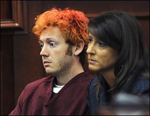 James Holmes, accused of killing 12 people in a shooting rampage in an Aurora, Colo., movie theater, appears in Arapahoe County District Court with defense attorney Tamara Brady in Centennial, Colo.