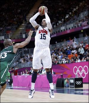 USA's Carmelo Anthony (15) shoot a jumper over Nigeria's Derrick Obasohan (13) during a preliminary men's basketball game at the 2012 Summer Olympics, Thursday.