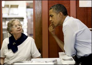 President Obama samples some fudge given to him to taste by LaDonna Secrist, owner of the Squirrel's Den, during his Wednesday visit to Mansfield.