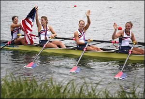 U.S. rowers, from right, Adrienne Martelli, Megan Kalmoe, Kara Kohler, and Natalie Dell wave to fans after winning the bronze medal for the women's rowing quadruple sculls on Wednesday.