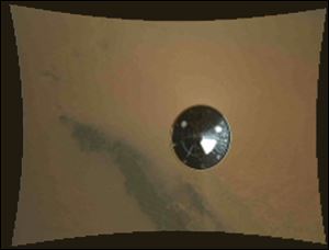 In this frame provided by NASA of a stop motion video taken during the NASA rover Mars landing, the heat shield falls away during Curiosity's descent to the surface of Mars on Sunday.
