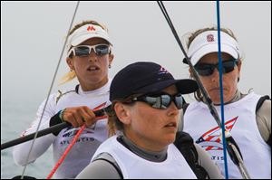 The U.S. women's sailing team of Anna Tunnicliffe, right, Molly Vandemoer, left, and Debbie Capozzi center, lost their first two races in a best-of-five quarterfinal Tuesday.