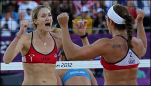 Kerri Walsh Jennings, left, and Misty May-Treanor, right, react during their quarterfinal women's beach volleyball match against Italy Sunday.
