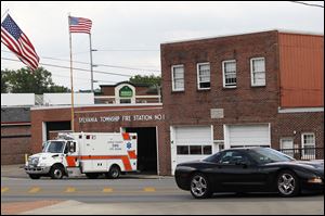An ambulance rolls out of the Sylvania Township Fire Station No. 1 in downtown Sylvania. Heavy afternoon traffic near the station has been cited as a concern while the city debates whether or not to rebuild the station in the same location.