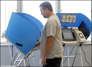 Scott Eisenhauer casts his vote at the Lake Township administration building. A 6.75-mill school levy passed.