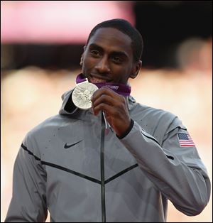 Silver medalist Erik Kynard of the United States shows off his medal during the ceremony for the Men's High Jump Wednesday.